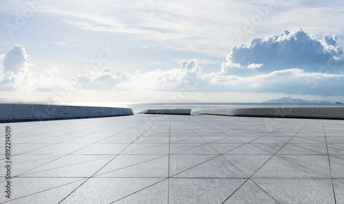 Fototapeta Naklejka Na Ścianę i Meble -  Empty square floor and coastline with white sky clouds background