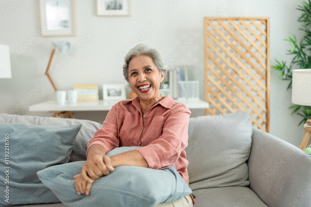 Portrait of senior woman smiling, looking at camera in living room at home. Portrait of senior woman smiling, looking at camera in living room at home.