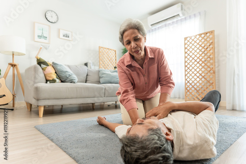 Asian senior wife helping elderly husband from falling on the ground. 