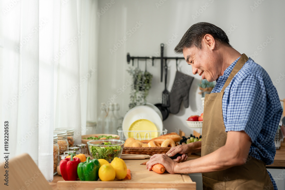 Fototapeta premium Asian senior elderly man cooking foods for breakfast in kitchen at home.