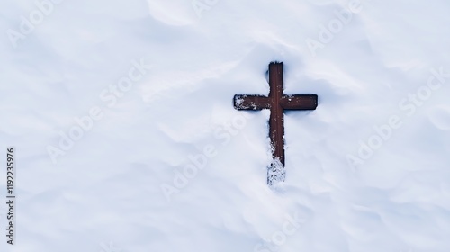 A single cross buried in fresh snow, half revealed, minimal and clean, top down view photo