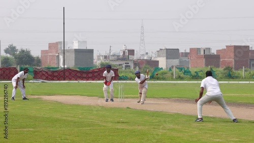Batsman hits the ball, Fielder taking the catch and celebrating a wicket in a cricket match