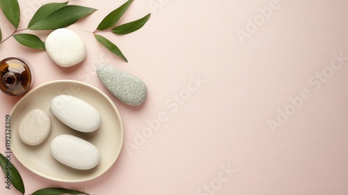 Zen-inspired spa tools, including gua sha stones and essential oils, arranged on a soft lilac background. photo