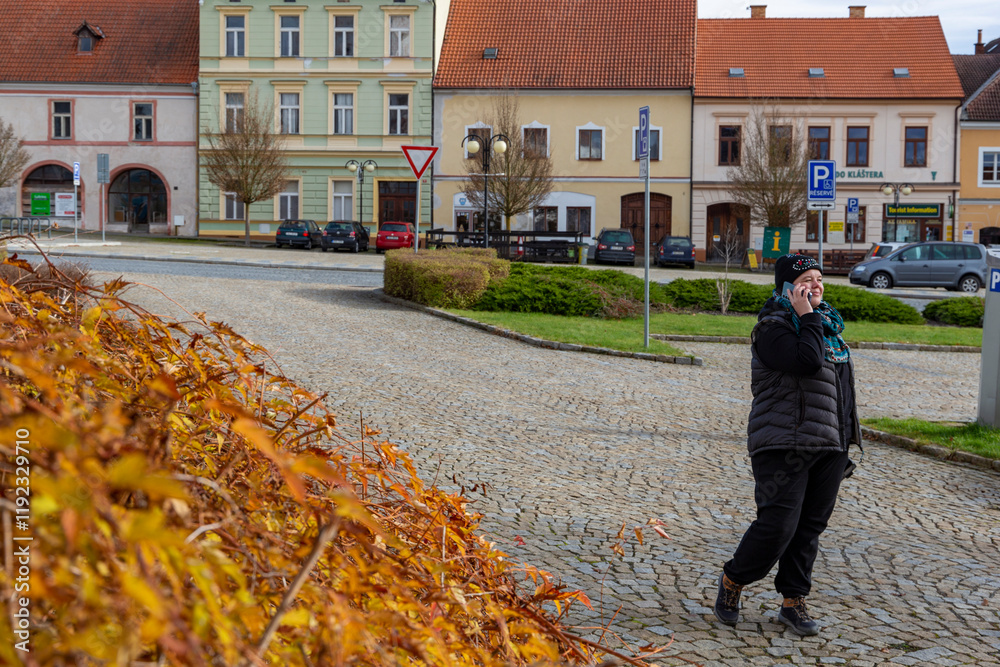 A woman walking through the city on an autumn day.