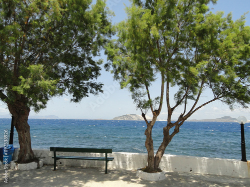 Parkbank direkt vor der Brandung auf Nisyros mit Blick auf Gyali und Kos photo