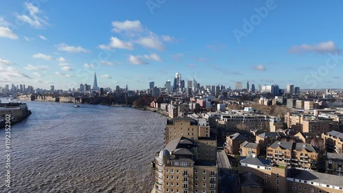 Panning drone aerial Wapping over River Thames city skyline in background photo