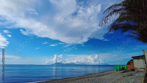 A sunny day at Mabua Beach, Surigao del Norte, Philippines, offering a panoramic view of the Gulf of Leyte and the distant beauty of Panaon Island. photo