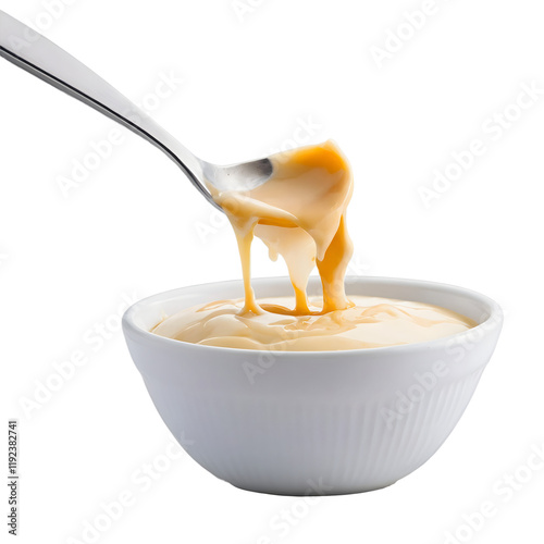 Creamy Condensed Milk Pouring from a Spoon Ideal for Enhancing Desserts and Recipes with Rich Flavor