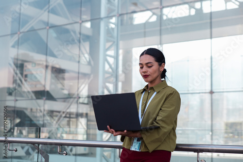 Woman using laptop in office premises photo