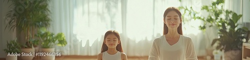 Free Download Yoga mother idea. Mom and daughter practicing yoga together in a serene indoor space with natural light. - GFXLoad