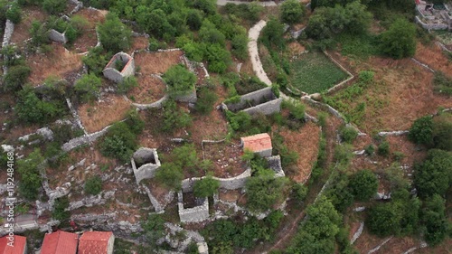 Aerial view of old village with stone houses with stone fence wall photo