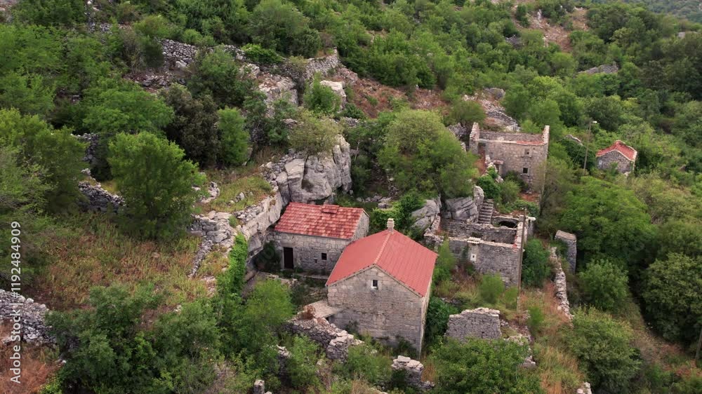 Aerial view of old stone house that is located beside a small cliff Aerial view of old stone house that is located beside a small cliff