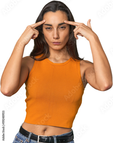 Hispanic young woman focused on a task, keeping forefingers pointing head. photo