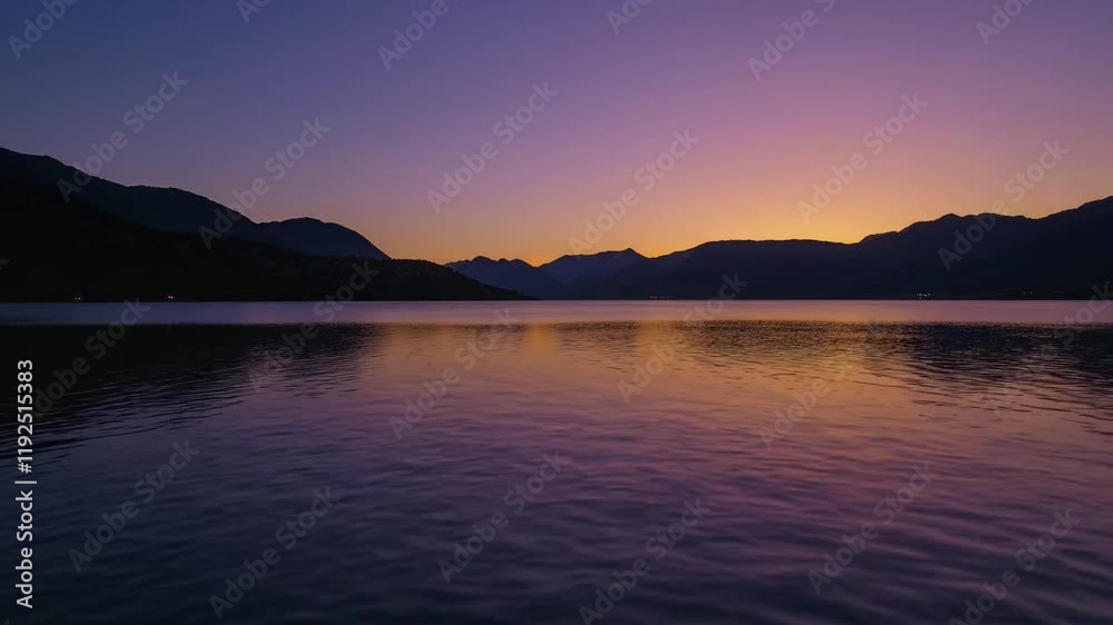 Serene Twilight Over Mountain Lake with Calm Water Reflection and Majestic Peaks Under a Colorful Sky at Dusk Serene Twilight Over Mountain Lake with Calm Water Reflection and Majestic Peaks Under a Colorful Sky at Dusk