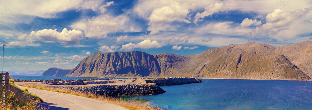 Seascape during sunset. Rocky sea coast. Open sea with blue sky. Honningsvag cruise port