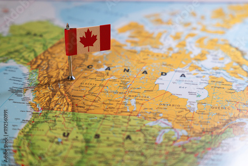 A Canadian flag pinpointed on a map of Canada, symbolizing national identity and geographical location