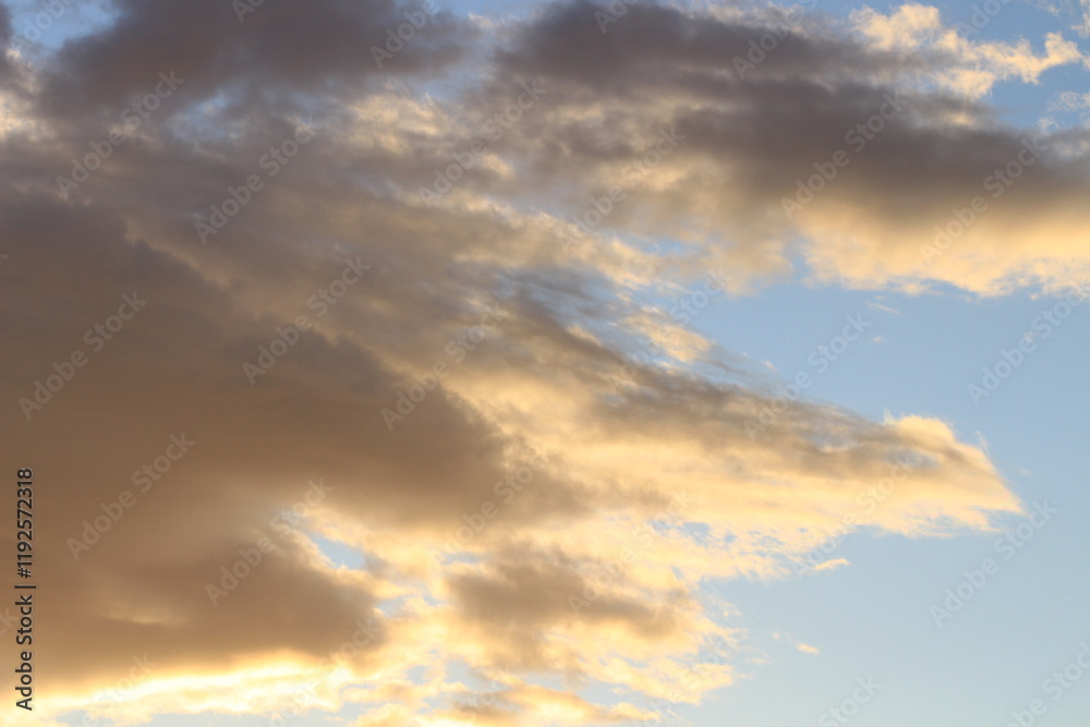Sunset in the clouds. Fluffy clouds in the blue sky at sunset. A bunch of clouds. Beautiful sky at sunset. Sunset in the clouds. Fluffy clouds in the blue sky at sunset. A bunch of clouds. Beautiful sky at sunset.