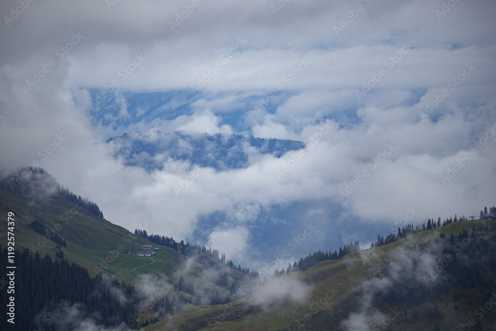 Majestic mountains shrouded in mist revealing clear blue skies in Austria Majestic mountains shrouded in mist revealing clear blue skies in Austria
