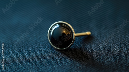 Close up of an elegant black lapel pin showcasing sophistication and style on a textured fabric background