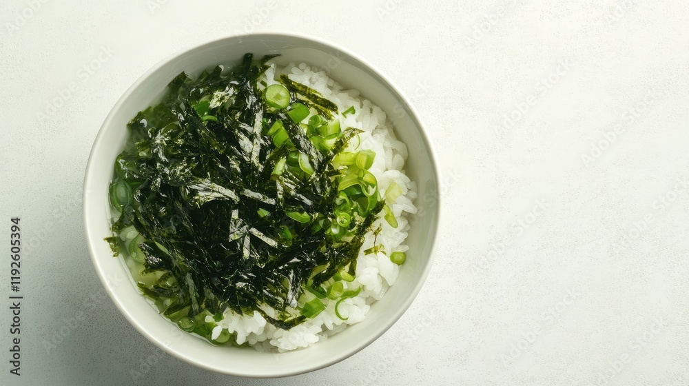 Bowl of white rice topped with fresh seaweed and scallions showcasing delicious ramen noodle preparation ideal for culinary illustrations. Bowl of white rice topped with fresh seaweed and scallions showcasing delicious ramen noodle preparation ideal for culinary illustrations.