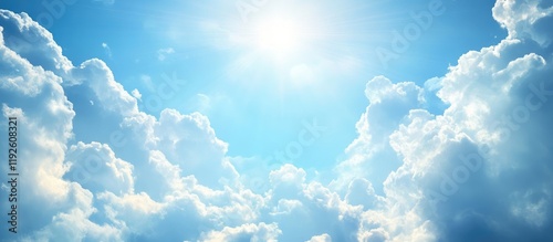 Serene blue sky with fluffy white clouds and radiant sun rays providing ample copyspace for text or promotional content. photo