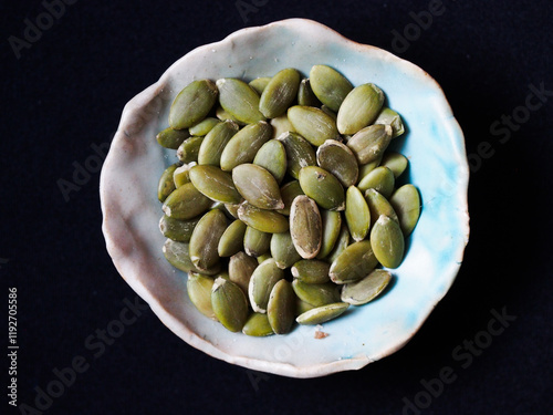 Green pumpkin seeds in a bowl