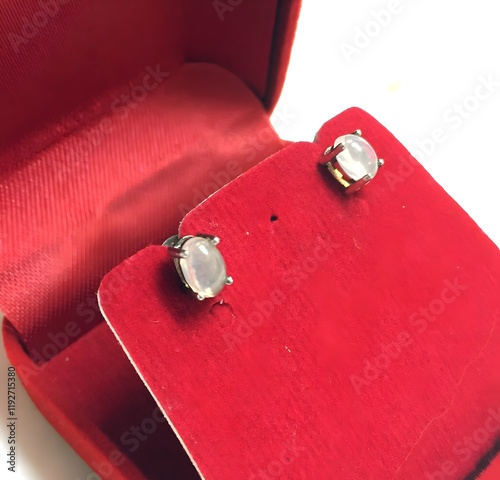 Elegant silver Opal stud earrings displayed in a red velvet box photo