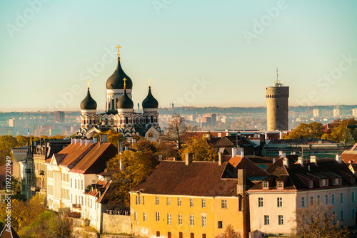 Aerial view of a cityscape with a prominent Alexander Nevsky Cathedral featuring black domes and a round tower against a clear sky in the old town of  Tallinn in Estonia photo