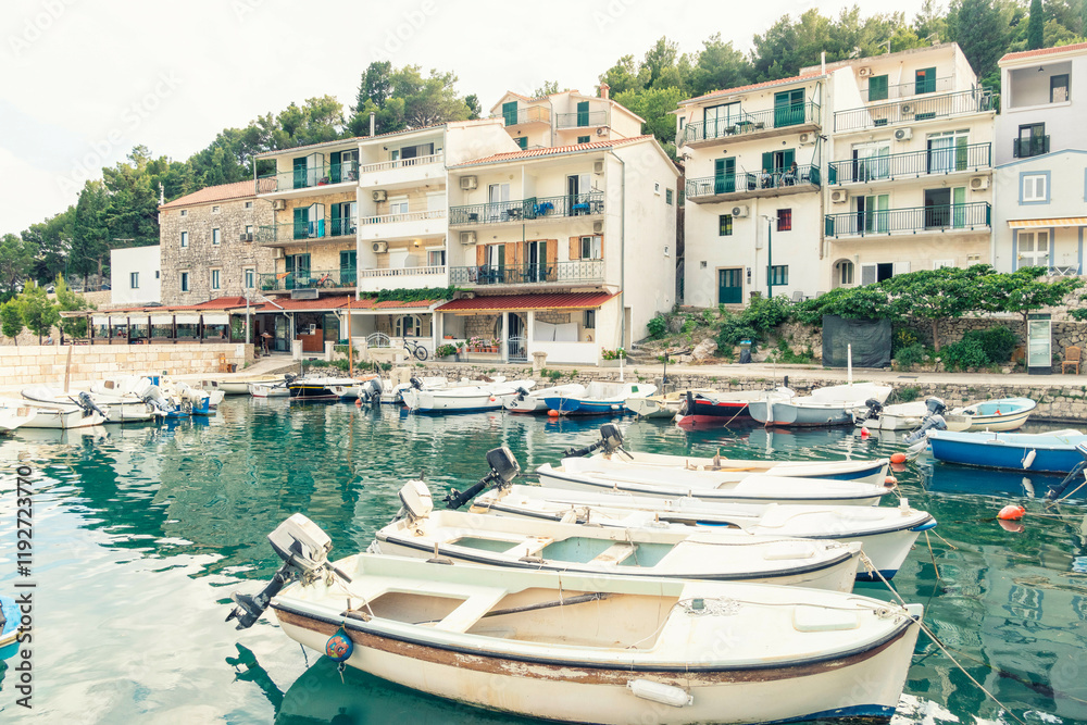 Coastal town of Drvenik with moored boats in the foreground and multistory buildings in the background, , Drvenik, Croatia. Coastal town of Drvenik with moored boats in the foreground and multistory buildings in the background, , Drvenik, Croatia.