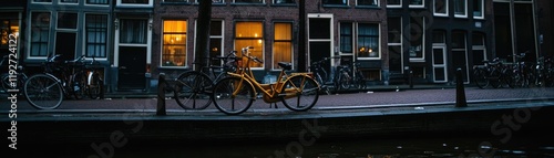 Night canal, yellow bike, city buildings.  Travel stock photo