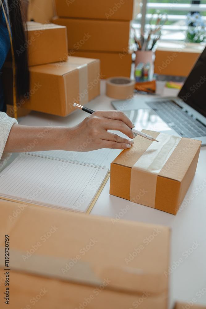 a designer is preparing products to send to customers by mail, a female dressmaker is selling her products online to increase her income, female industrial tailor at work a designer is preparing products to send to customers by mail, a female dressmaker is selling her products online to increase her income, female industrial tailor at work