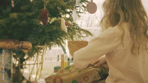 Sisters unwrap gifts for Christmas in the morning