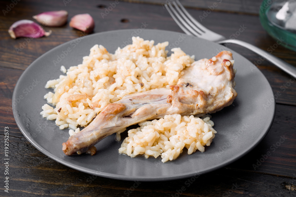 Delicious rice with tender roasted rabbit on a plate Delicious rice with tender roasted rabbit on a plate