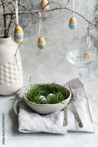 Easter table decoration with hanging painted eggs photo