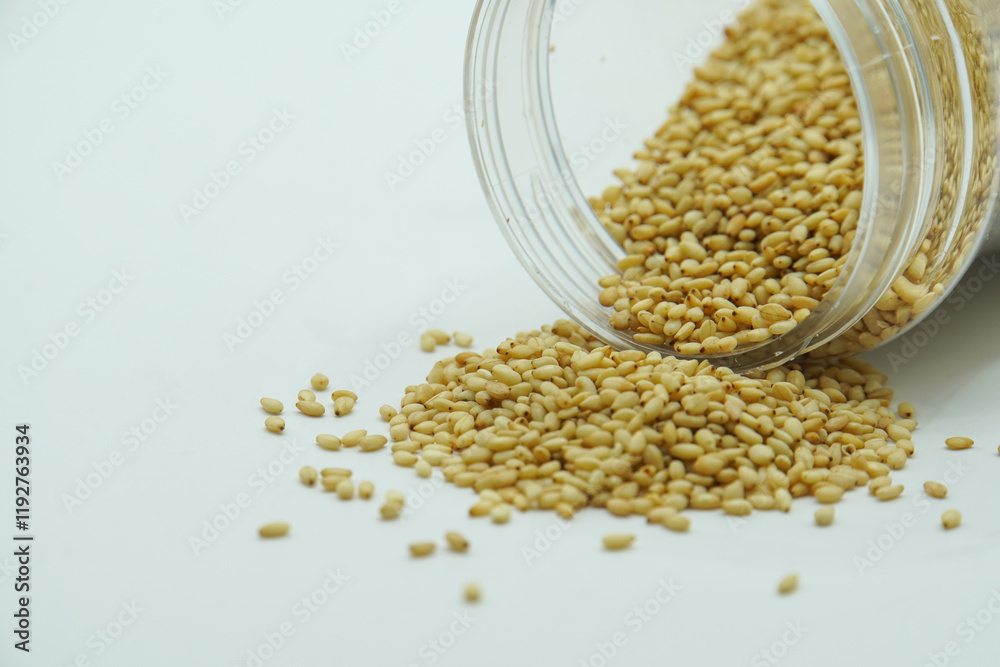Sesame Seeds falling from glass jar, sesame seeds Sesame Seeds falling from glass jar, sesame seeds