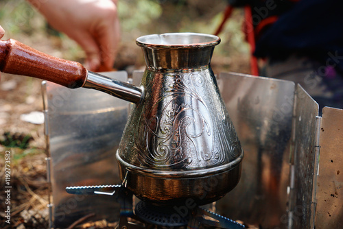 Photos a painted turk with a wooden handle stands on a gas burner - the process of brew