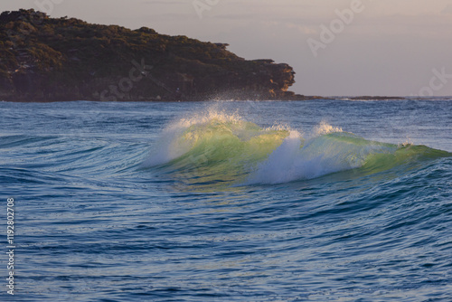 Fototapeta Naklejka Na Ścianę i Meble -  Breaking wave with the morning light.