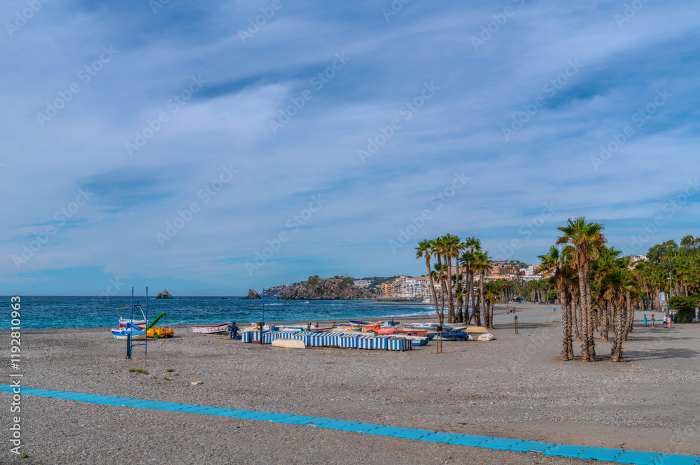 Obraz premium Almunecar beach Spain with palm trees and boats Costa del Sol Andalusia