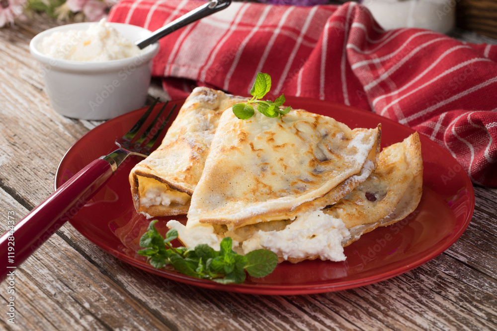 Crepes with ricotta cheese and blackcurrant jam. Crepes with ricotta cheese and blackcurrant jam.