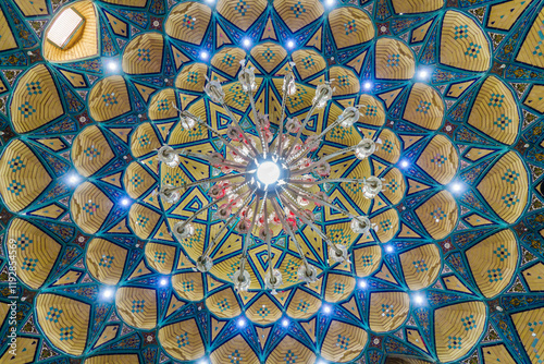 Bottom view of the ceiling at the shrine of Imamzadeh Mohammed Hilal ibn Ali shrine in the city of Aran and Bidgol, Iran. Luster is visible (in the center). photo