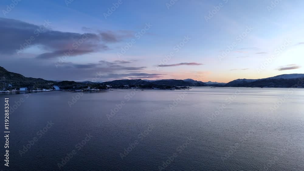 Aerial view from a drone panning across the Kvernes fjord at Raabukta bay, near Kristiansund, Norway Aerial view from a drone panning across the Kvernes fjord at Raabukta bay, near Kristiansund, Norway