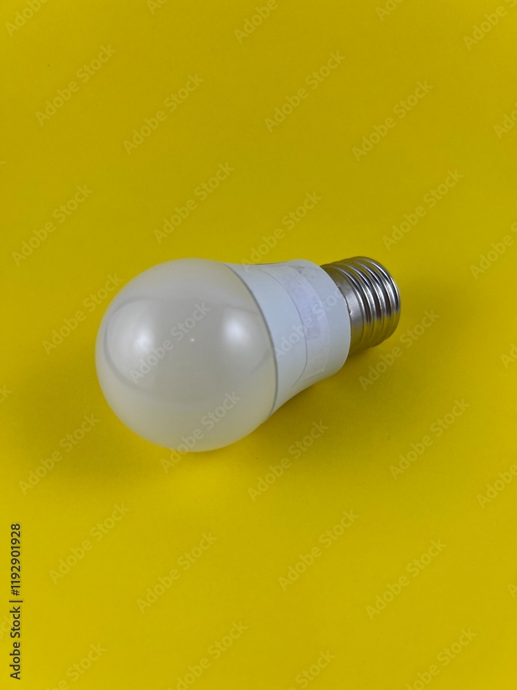 White LED light bulb isolated on yellow background