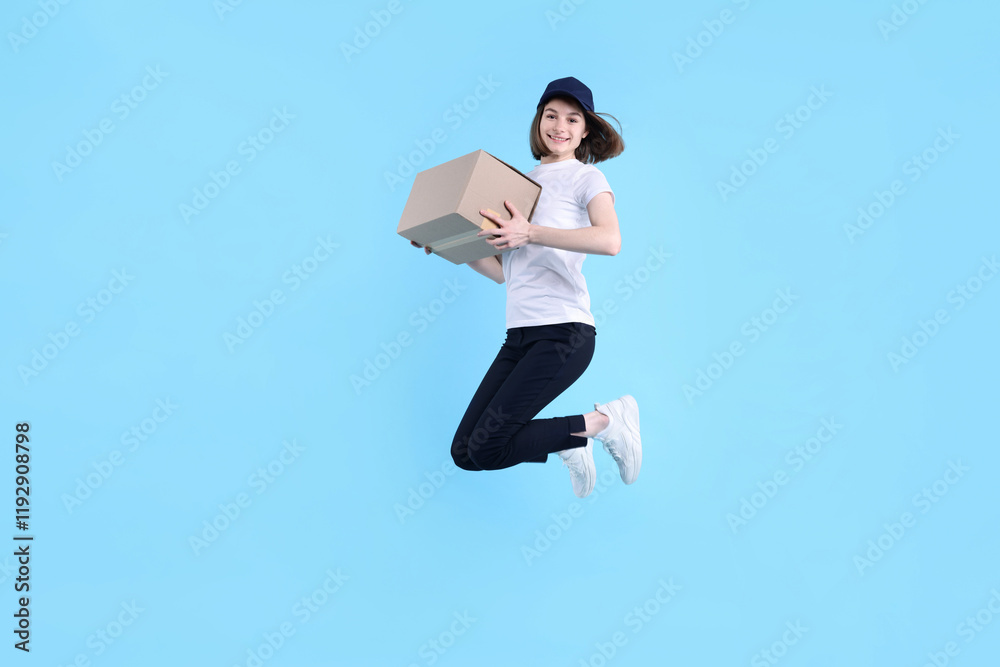 Happy postwoman with parcel jumping on light blue background Happy postwoman with parcel jumping on light blue background