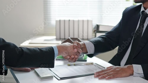 Business people seller explain to buyer or mortgage and signing on house purchase contract agreement for loan financial and pay cash money for real estate house properties. Dealing and handshake.