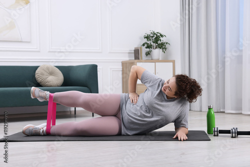 Woman training with resistance band at home