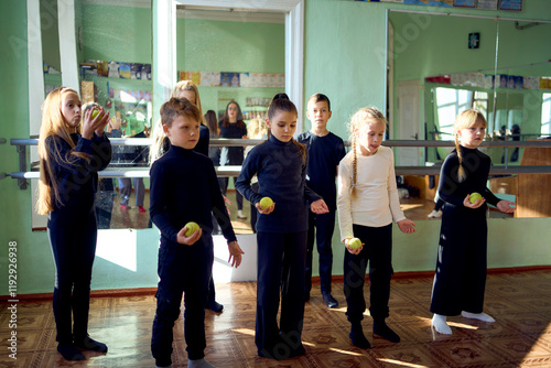 a group of pre-teens perform a teacher's task during an acting class, training of coordination, attention and concentration with balls