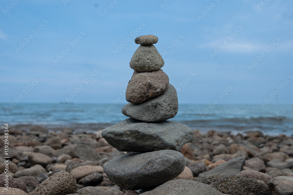 Serene Seascape: A Balanced Rock Cairn by the Ocean Serene Seascape: A Balanced Rock Cairn by the Ocean