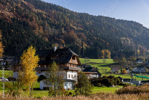 Austrian lake Ossiacher See in Carinthia with the village of Ossiach and the Alps in the background in autumn