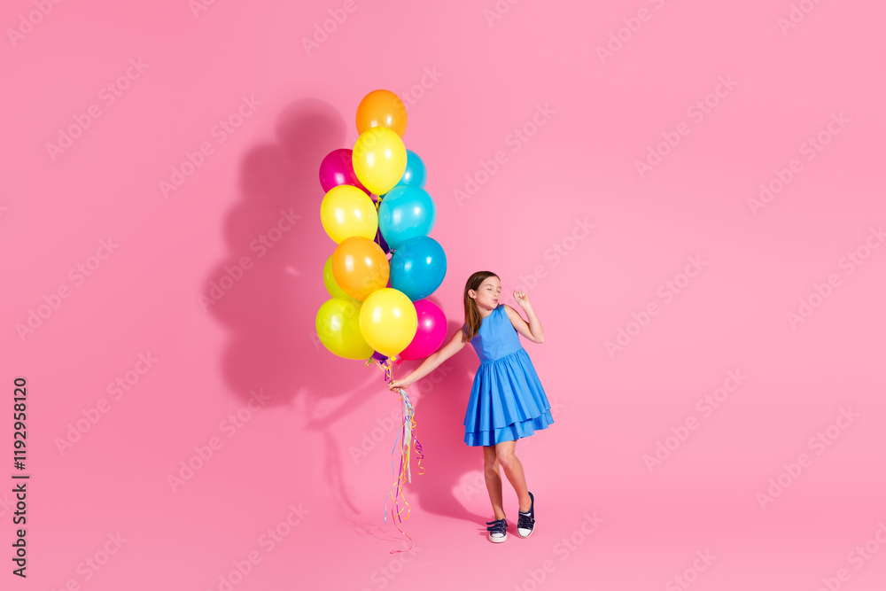 Charming young girl holding colorful balloons against a vibrant pink background Charming young girl holding colorful balloons against a vibrant pink background