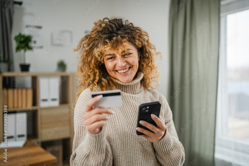 adult woman with curly hair use cellphone and credit card for payment adult woman with curly hair use cellphone and credit card for payment